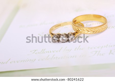 Beautiful diamond engagement ring with wedding band and wedding invitation