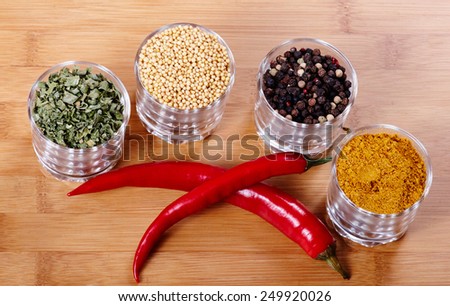 Fragrant spices with red pepper. Isolated on wooden background