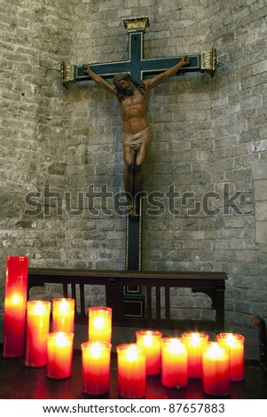 Jesus Christ on cross with candles in foreground
