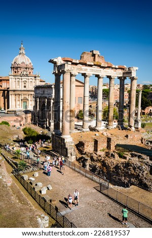 ROME, ITALY - 26 SEPTEMBER 2014. Tourists visiting Roman Forum, Ancient Rome civic center of empire capital, landmark of modern Italy and world heritage.