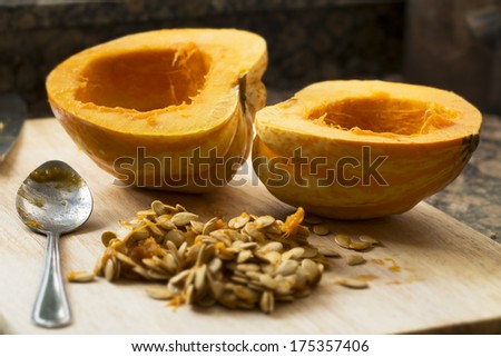 Winter squash cut in half with spoon and seeds scooped out.