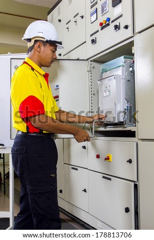 electrician at work on main switch board
