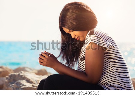 Young girl praying in nature by the Sea