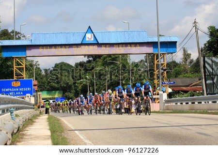 JASIN, MELAKA, MALAYSIA - FEBRUARY 26 : The largest group of cyclists from various teams cycle during Stage 3 of the Tour de Langkawi from Melaka to Parit Sulong on February 26, 2012 in Melaka, Malaysia.