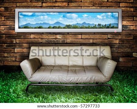 Nature picture White Sofa Old Brick Wall and New Green Grass