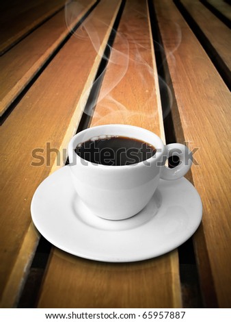 White ceramic of coffee on wood line table
