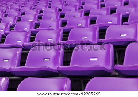 Purple Empty plastic seats at stadium open door sports arena