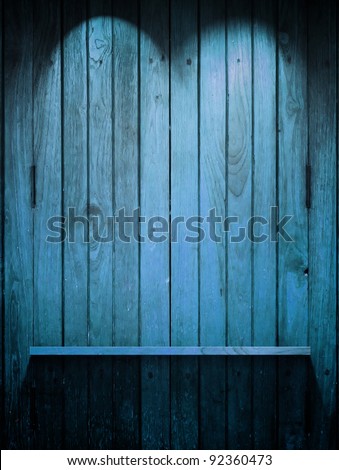 Empty Wood blue Shelf on wall with Top light and shadow