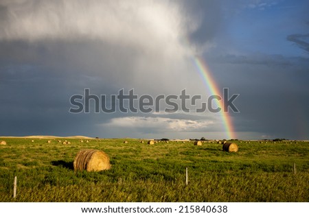 Storm Clouds Saskatchewan with rainbow and hay bales