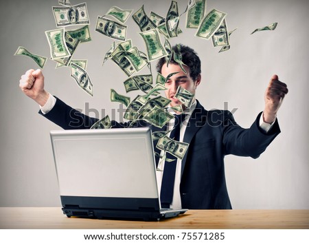 happy man with laptop and money explosion