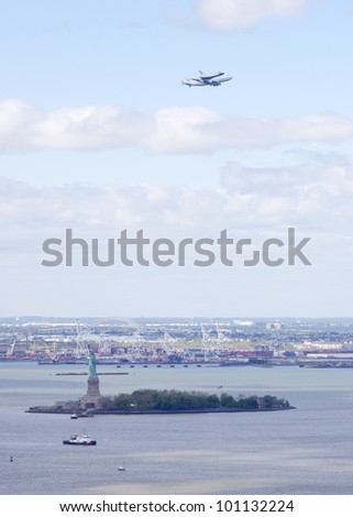 NEW YORK - Oct 8:The space shuttle Enterprise mounted on NASA\'s 747 Shuttle Carrier Aircraft flies over the Statue of Liberty on October 8, 2011 in New York City. It will be displayed on The Intrepid.