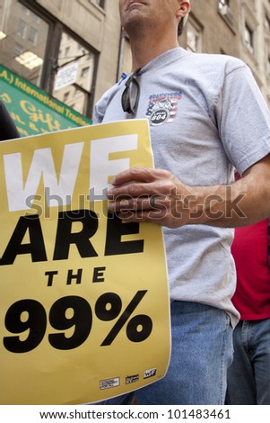 NEW YORK - MAY 1: Protesters march to Union Square from Bryant Park during Occupy Wall St \'May Day\' protests on May 1, 2012 in New York, NY. Slogans on signs include \'We Are The 99 percent\'.