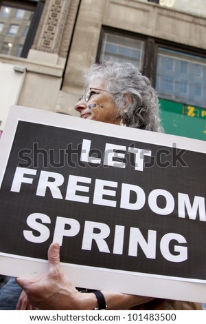 NEW YORK - MAY 1: Protesters march to Union Square from Bryant Park during Occupy Wall St \'May Day\' protests on May 1, 2012 in New York, NY. Slogans on signs include \'Let Freedom Spring\'.