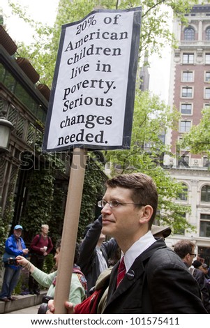 NEW YORK - MAY 1: A protesters sign that says \'20% of American children live in poverty. Serious changes needed\' in Bryant Park at the Occupy Wall St \'May Day\' protests on May 1, 2012 in New York, NY.