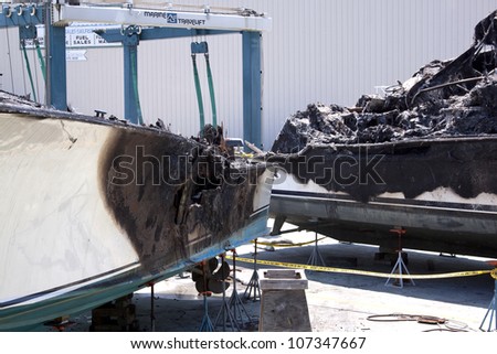 STUART, FL - MARCH 30: The charred fiberglass hulls of two boats now in dry dock at the Sailfish Marina in Stuart, Florida on March 30, 2011. The boats were destroyed in the fire.