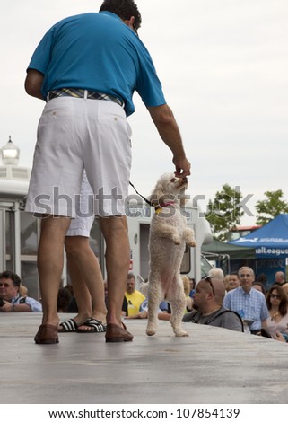 RIDGEFIELD PK, NJ-JULY 14: ABC Channel 7 meteorologist and dog lover, Bill Evans, feeds his dog peanut butter on stage at the 2nd Annual Bark In The Park on July 14, 2012 in Ridgefield Park, NJ.