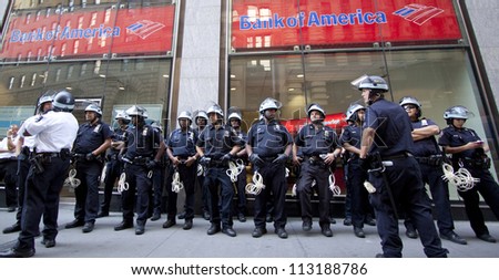 NEW YORK - SEPT 17: Police in riot gear assemble in front of a Bank of America branch on Broadway on the 1yr anniversary of the Occupy Wall St protests on September 17, 2012 in New York City, NY.