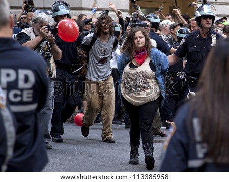 NEW YORK - SEPT 17: Two unidentified protesters being arrested on the 1yr anniversary of the Occupy Wall St protests on September 17, 2012 in New York City, NY.