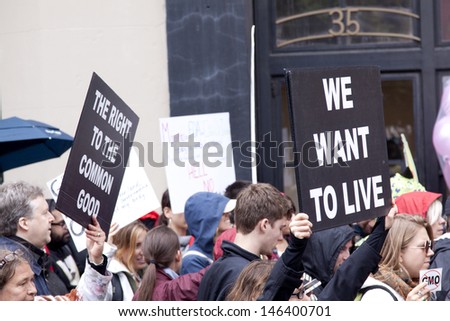 NEW YORK-MAY 25: A protestor holds a sign that says \'We Want To Live\' above the crowd at the March Against Monsanto on May 25, 2013 in New York. The rally was part of a global movement against GMO\'s.