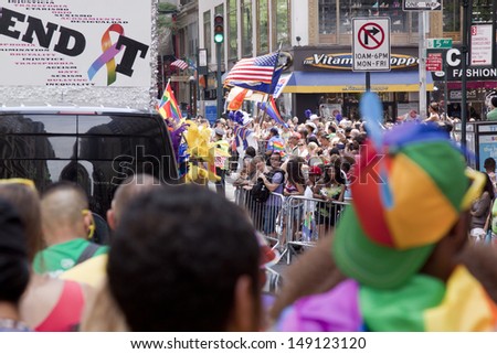 NEW YORK-JUN 30: Spectators watch as float with the words \'End It\' begins move into place in the 44th Annual NYC Pride March down 5th Avenue on June 30, 2013 in Manhattan.
