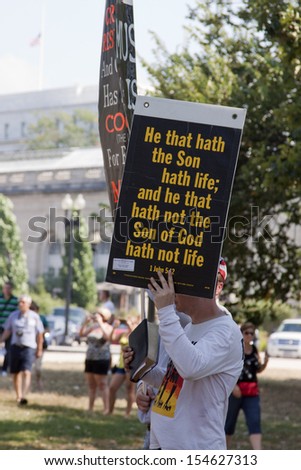 WASHINGTON-SEPT 11: Men opposed to the 9/11 Truthers hold signs with religious quotes on September 11, 2013 in Washington, DC. Christian groups aimed to counter the Million Muslim March.