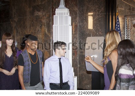 NEW YORK-OCT 16, 2014: Laverne Cox, actress in \'Orange Is The New Black\' flips the switch with cast members from her documentary \'The T Word\' at the ceremony to light the Empire State Building purple.