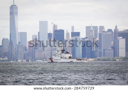 STATEN ISLAND, NY - MAY 20 2015: USCGC Spencer (WMEC 905) passes the Freedom Tower of One World Trade Center in Lower Manhattan on the Hudson River during the Parade of Ships which begins Fleet Week.