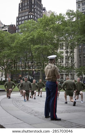 NEW YORK - MAY 21 2015: A group of US Marines doing lunges during an early morning boot camp exercise in Bryant Park at Marine Day during Fleet Week NY 2015.