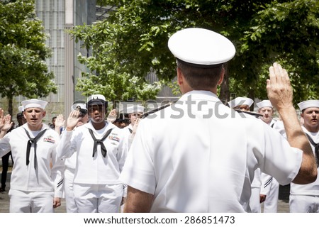 NEW YORK - MAY 22 2015: Admiral Phil Davidson, Commander, US Fleet Forces Command, swears in personnel during the re-enlistment and promotion ceremony at the National September 11 Memorial site.