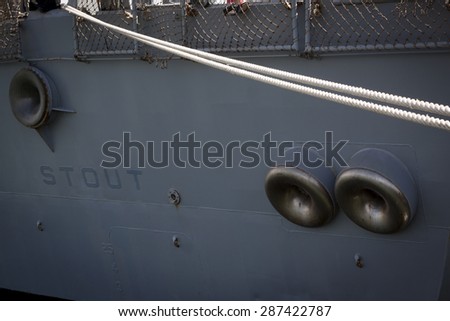 STATEN ISLAND, NY - MAY 24 2015: Lines securing the stern of the stern of the guided-missile destroyer USS Stout (DDG 55) moored at Sullivans Pier during Fleet Week NY 2015.