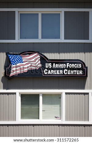 NEWTON, NJ-JUL 2015: The Armed Forces Career Center sign with the American Flag on it hangs on the side of the military recruitment station for the Army, Navy, and Air Force in Newton, NJ.