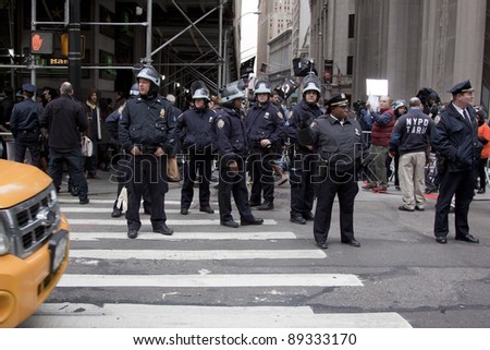 NEW YORK - NOV 17:  A police officer directs traffic on Broadway at Wall St near the entrance to the New York Stock Exchange on the 'Day of Disruption' on November 17, 2011 in New York City, NY.