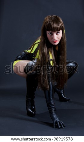 Model in sexy yellow and black outfit with thigh high boots and garter