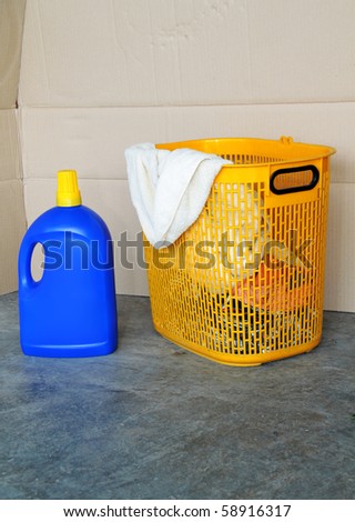 Dirty laundry in the basket for washing with detergent. Concept of daily household chore, contain clipping path.