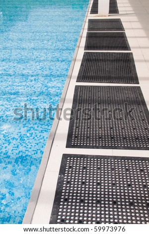 Anti-slip rubber mat beside children swimming pool. Concept of children safety precaution item.