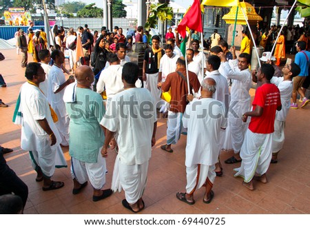 BATU CAVE, MALAYSIA - JAN 20 : A group of indians are singing and dancing in front a hindu temple during Thaipusam on January 20, 2011 at Batu Cave temple, Malaysia.