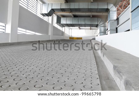 Ascending cement road with anti-slip texture. Concept of road safety measure.