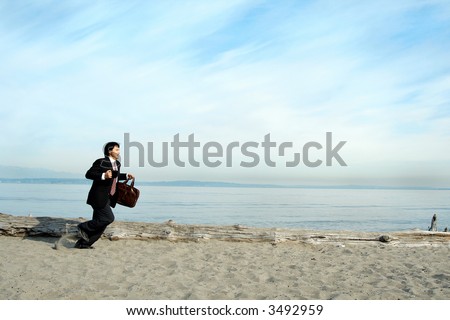 A businessman running on the beach carrying a cup and a bag