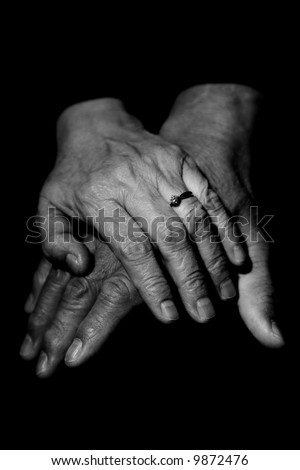 A couple of mature couple holding hands in black and white