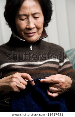 A shot of a senior asian woman knitting