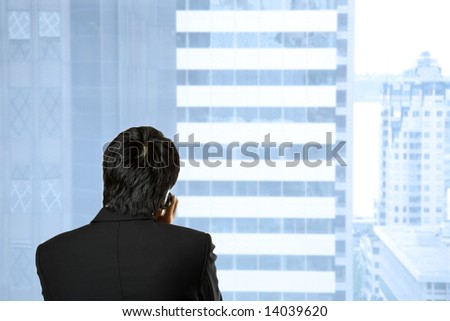A shot of a businessman talking on the cell phone at his office