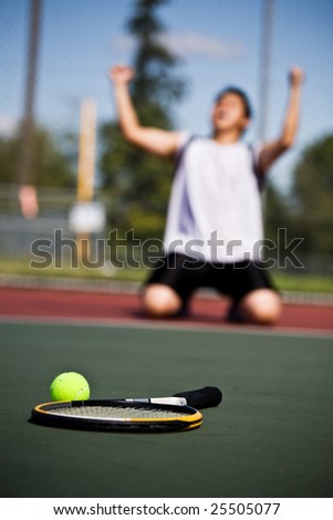 A happy tennis player in joy after winning