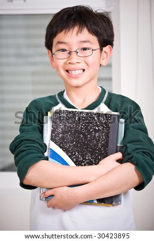 A shot of an asian kid carrying books