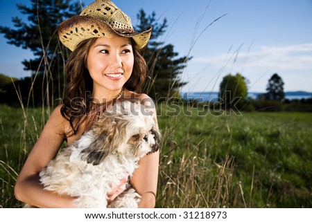 A beautiful girl with her dog outdoor during summer