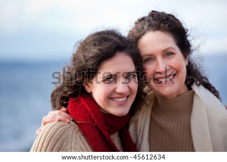 A portrait of a mother and her daughter on the beach