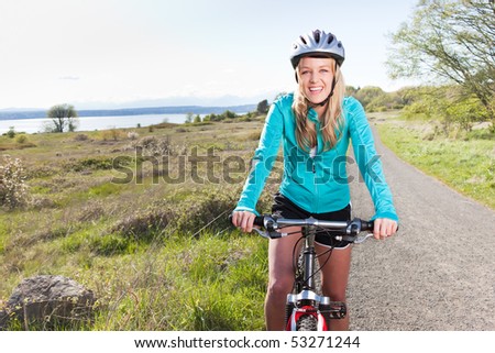 A sporty woman riding a bicycle outdoor