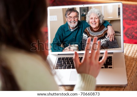 A shot of a senior couple video conferencing with their granddaughter