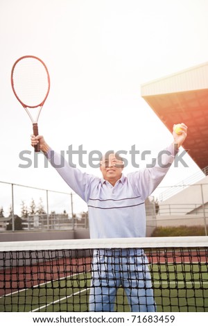 A shot of a happy asian senior tennis player playing tennis