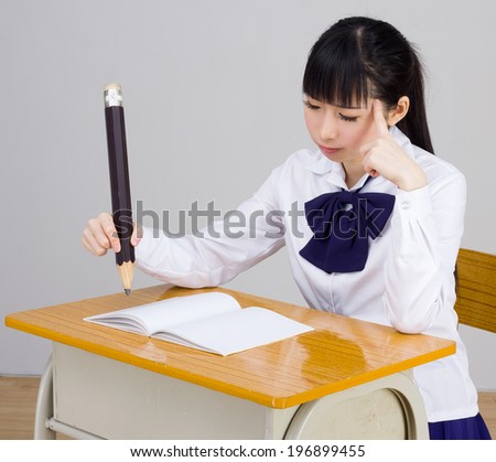 asian girl student in school study hard unusual pen