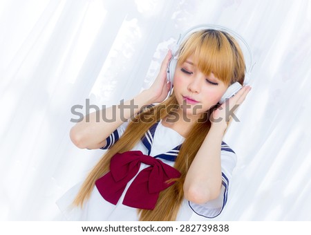 Asian girl in student sailor suit japanese style listen to music